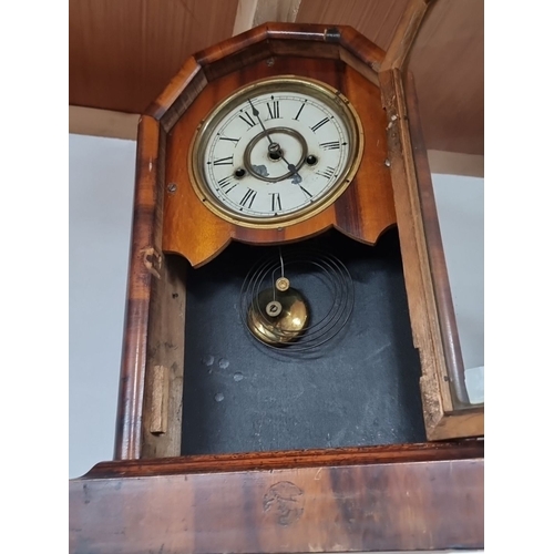 835 - Antique eight day wooden mantel clock with a brass pendulum and Roman numeral dial. It exhibits Vict... 