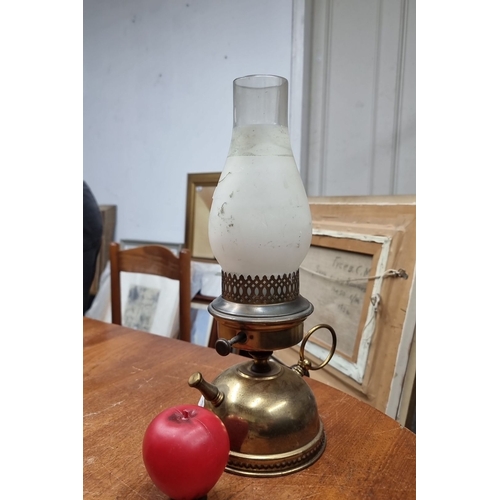 858 - Antique brass oil lamp with frosted glass chimney and electric conversion. Features ornate detailing... 