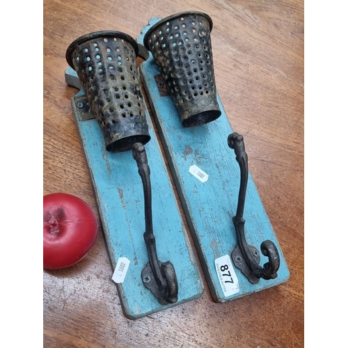 877 - A pair of vintage wall-mounted wrought iron and blue wooden sconces with perforated metal candle hol... 