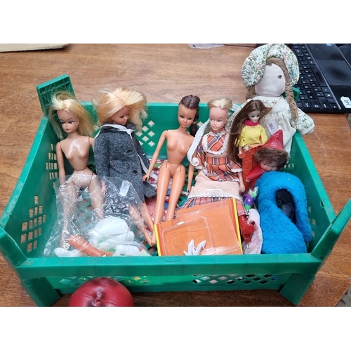 879 - A cart containing a mixed lot of vintage dolls in decorative clothing, accessories and footwear. The... 