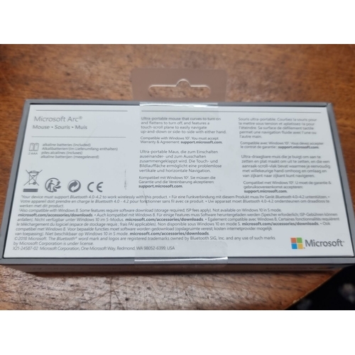 881 - Microsoft Arc Mouse, new in box. Features Bluetooth connectivity, and touch-scroll capabilities. Inc... 