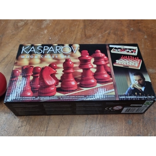 893 - A Kasparov Wood Chess Set. Finely crafted chess pieces and a folding wooden board. Includes a chess ... 