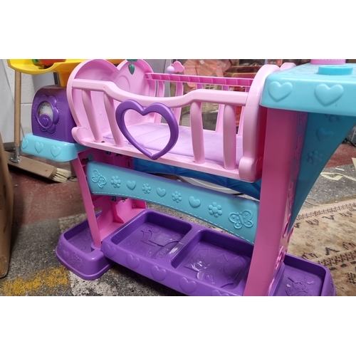 896 - A sweet 'Fisher-Price Doc McStuffins Baby All-in-One Nursery Playset, featuring vibrant pink and blu... 