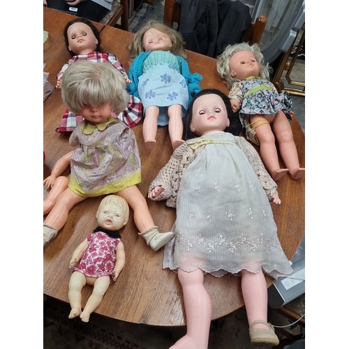 898 - A box containing six vintage dolls, varying in sizes and outfits. With one marked 