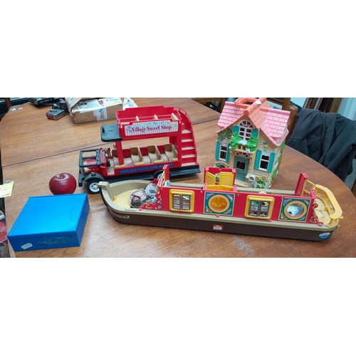 900 - A box containing vintage children's toys including a Fisher Price dolls house. The Following Lots ar... 