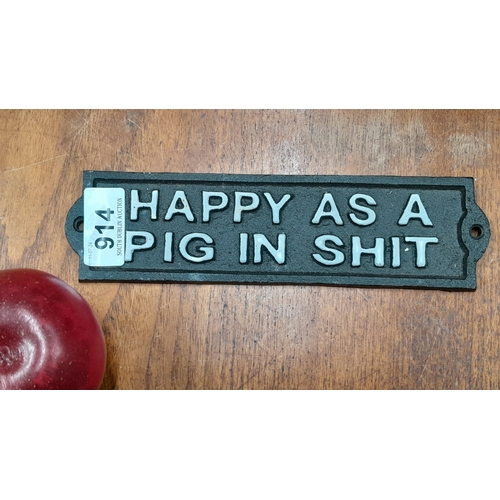 914 - A humorous wall mounted cast iron plaque.