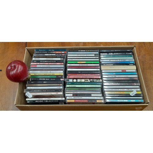 924 - A box containing a mixed assortment of CD's including artists such as AC/DC, Madness and Christina A... 