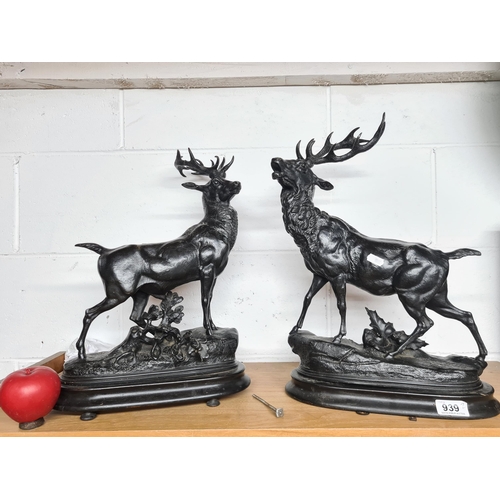 939 - Star lot : A pair of impressive large stag figures presented on wooden plinth bases.