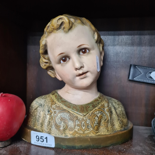 951 - A vintage bust of a young religious boy, hand painted featuring glass eyes.