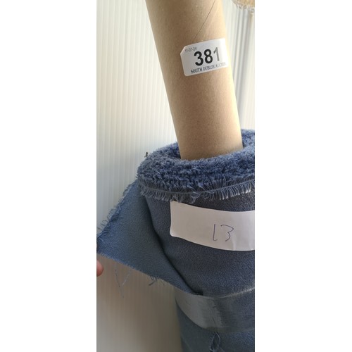 381 - A large bolt / roll of fabric in soft blue. Ideal for dress making projects.