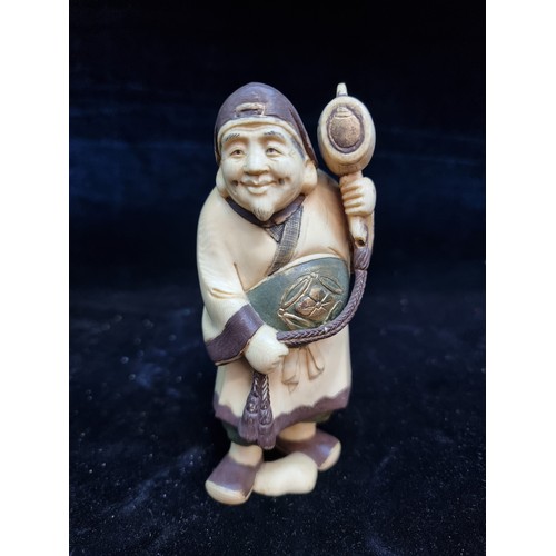 106 - Star Lot: An antique Japanese intricately carved bone figure with artist stamp to base. Housed in a ... 