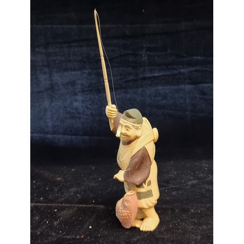 163 - Star Lot : A fabulous antique Japanese carved bone figure of a fisherman, displaying his catch, Supe... 