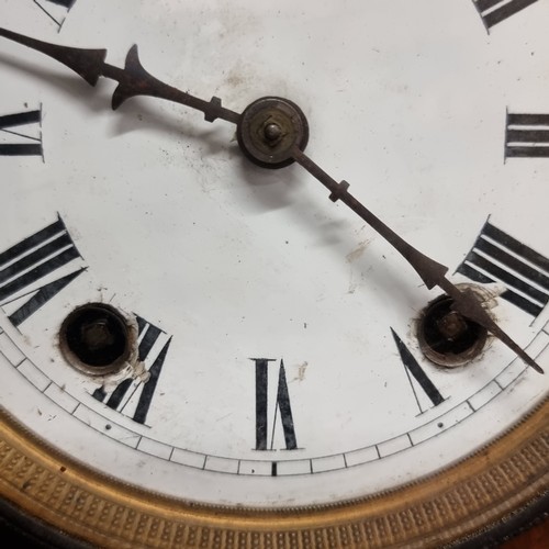 197 - An antique eight day walnut mantle clock featuring enamel face and Roman numeral dial. Nice example.