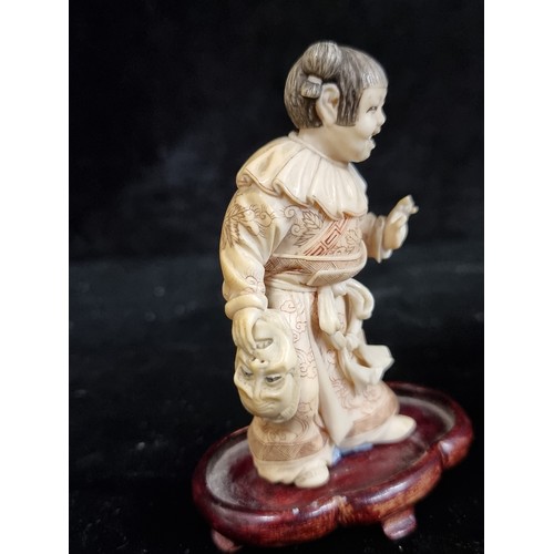 247 - Two antique Japanese bone carved figures including an unusual figure of a young Japanese child holdi... 