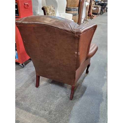 387 - A comfortable wing backed armchair in brown leather. Looks comfy. From a very fine home in Templemor... 