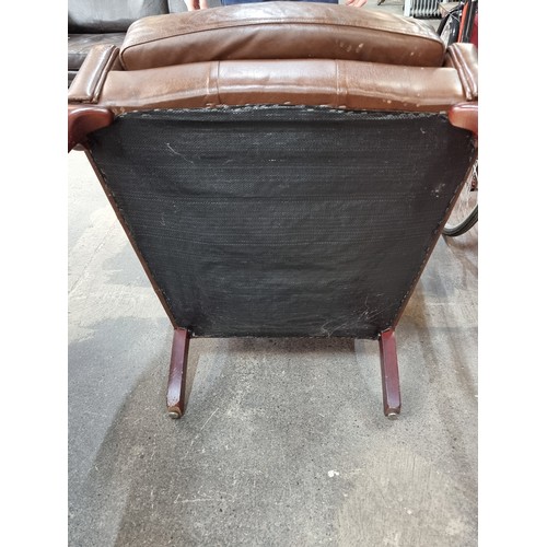 387 - A comfortable wing backed armchair in brown leather. Looks comfy. From a very fine home in Templemor... 