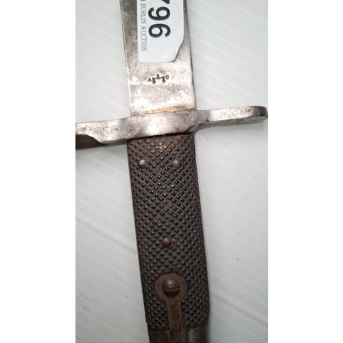 796 - Antique German bayonet, featuring a sawback blade and a metal handle with textured grip. Marked with... 