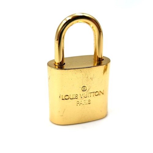 20 - An original designer Louis Vuitton gold metal padlock with two keys marked Louis Vuitton, Paris . We... 