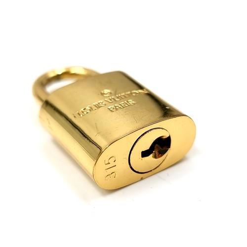 20 - An original designer Louis Vuitton gold metal padlock with two keys marked Louis Vuitton, Paris . We... 