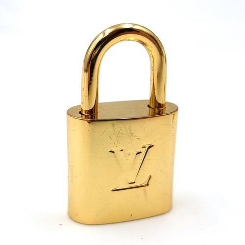 20 - An original designer Louis Vuitton gold metal padlock with two keys marked Louis Vuitton, Paris . We... 