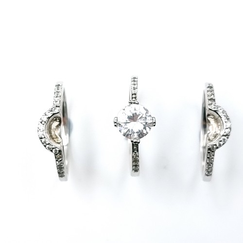 540 - A collection of three sterling silver rings that fit together with half moon gem set mount. Size - Q... 