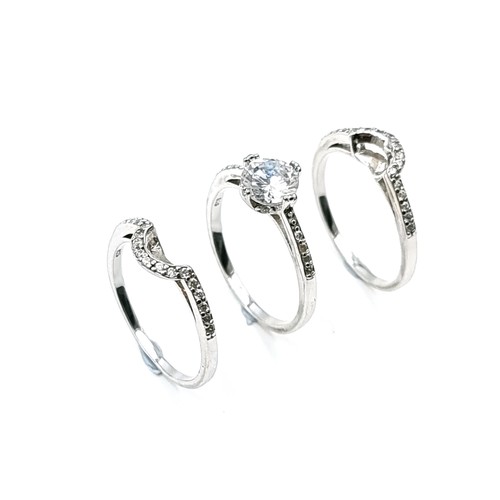 540 - A collection of three sterling silver rings that fit together with half moon gem set mount. Size - Q... 