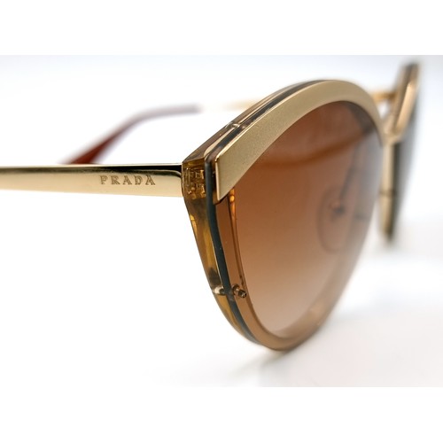 548 - A pair of as new Prada sunglasses made in Italy with reference details to stems. Comes with original... 