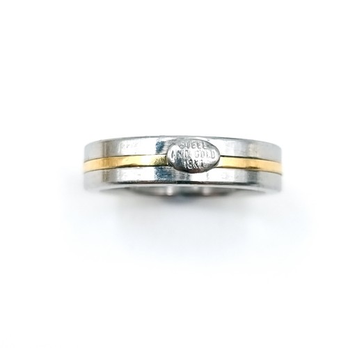 1064 - A gents pinkie ring in steel with an 18 carat gold band. Size M. Boxed.