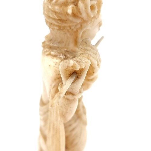 527 - Star lot : An antique Japanese bone carved figure depicting Lord Krishna playing the flute. Dimensio... 