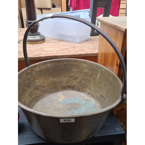 420 - Antique large brass preserve pot with a sturdy metal handle. Period: Heavy 19th century example.