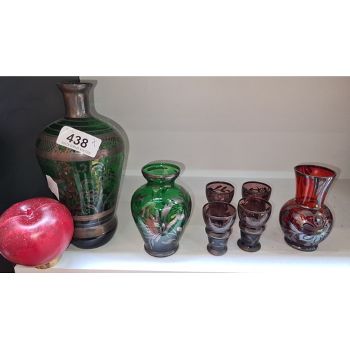 438 - Seven Bohemian coloured glass items with floral designs. The set includes a large green vase, a smal... 