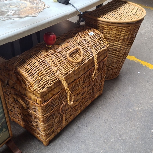 445 - Large woven wicker trunk and a wicker laundry hamper. The trunk features durable handles and braided... 