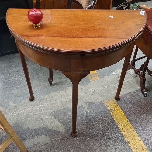 453 - A lovey Edwardian mahogany demi-lune flip over card table. It's transformable into a circular table ... 