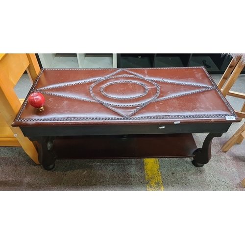 455 - An Unusual Wooden coffee table with studded brown leather top, featuring intricate geometric and cir... 