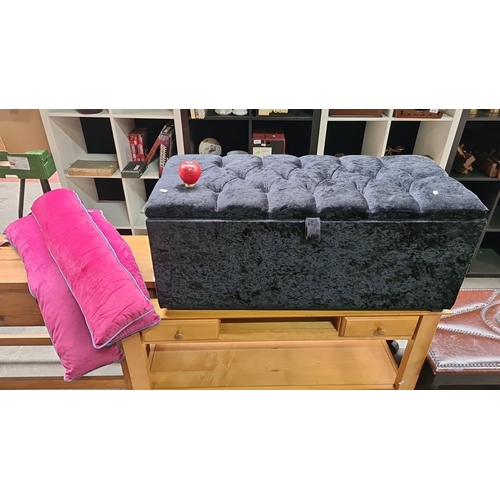 458 - Black tufted velvet storage bench with interior compartment, two vibrant pink velvet accent pillows.