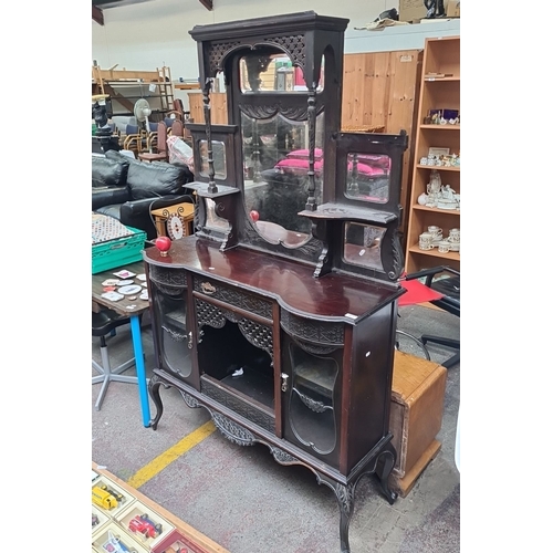 461 - Victorian mahogany sideboard with intricate carved detailing, beveled mirrored back, and multiple st... 