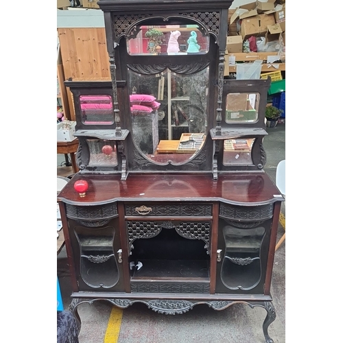 461 - Victorian mahogany sideboard with intricate carved detailing, beveled mirrored back, and multiple st... 