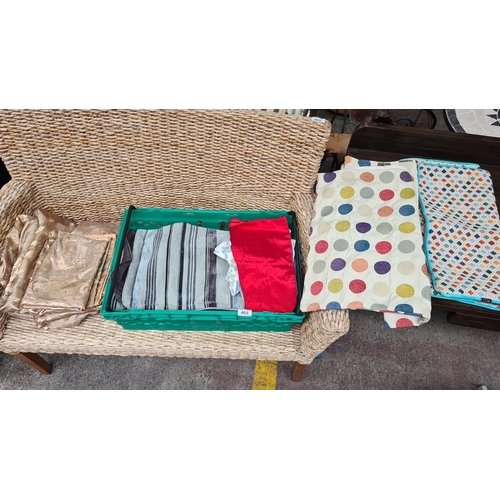 465 - Mixed lot of assorted textiles, including patterned cushions, striped fabric, floral curtains, and v... 