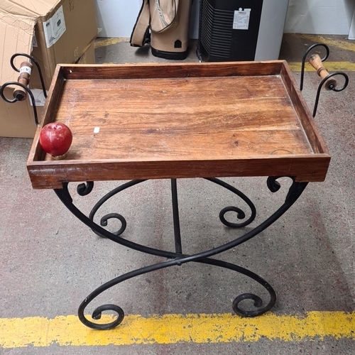 470 - Foldable wooden serving tray with wrought iron stand, featuring elegant scrollwork and wooden handle... 