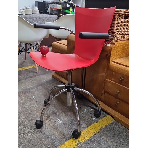 480 - Modern red swivel chair with chrome base and black armrests. Features adjustable height and smooth-r... 