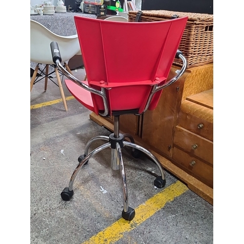 480 - Modern red swivel chair with chrome base and black armrests. Features adjustable height and smooth-r... 