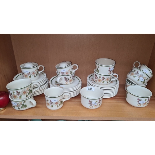 489 - Set of English ceramic  tea cups, saucers, and lidded sugar bowls. Features floral design with green... 