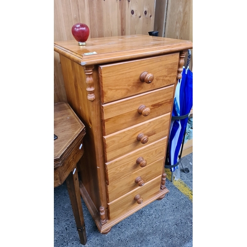 492 - Five-drawer pine chest, featuring rounded wooden knobs and turned column details. Measures approxima... 