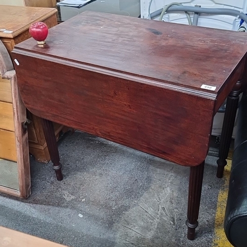 498 - A 1930s Mahogany Drop-Leaf Table with turned legs.