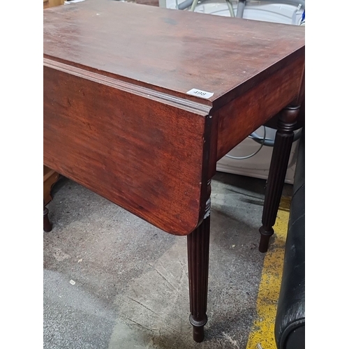 498 - A 1930s Mahogany Drop-Leaf Table with turned legs.