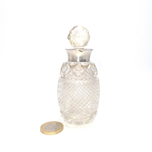 11 - A nice example of a glass hob nailed cut perfume bottle with sterling silver neck. Hallmarked Birmin... 