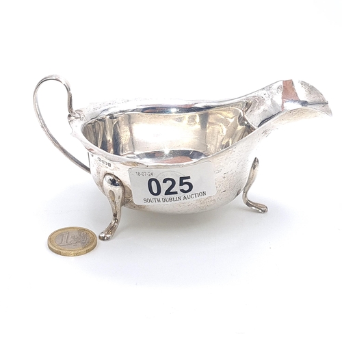 25 - A lovely Sterling Silver gravy boat with flying sea handle standing on three paw feet. Hallmarked Sh... 