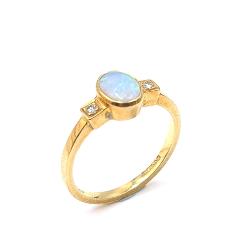 3 - Star Lot : A pretty opal and diamond ring set in 18 carat gold. Ring size K. Weight 2.59 grams.