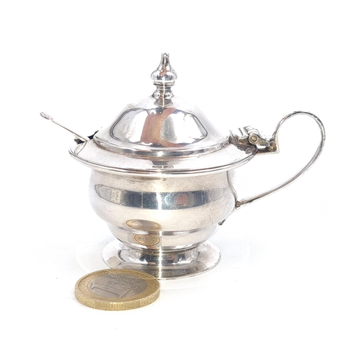 38 - A Sterling silver mustard pot with sterling silver spoon set with finial mounted lid. Hallmarked She... 