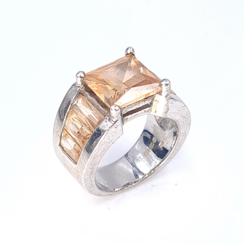 57 - A champagne gem stone ring set in sterling silver. Size L. Weight 12.19 grams. Boxed